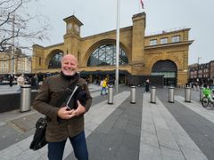 Malcolm Donald holding a folder outside King's Cross station
