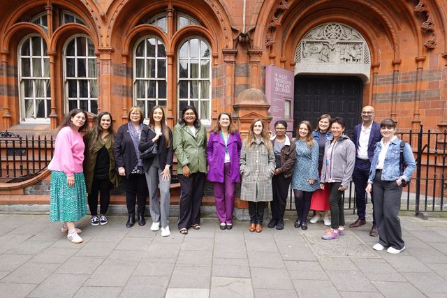 Food and Drink Federation colleagues pose for a group photo in front of an ornate red terracotta building in Soho